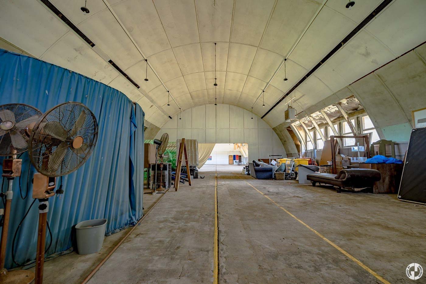 scheyville inside the dome facility with curtains bed electric fans